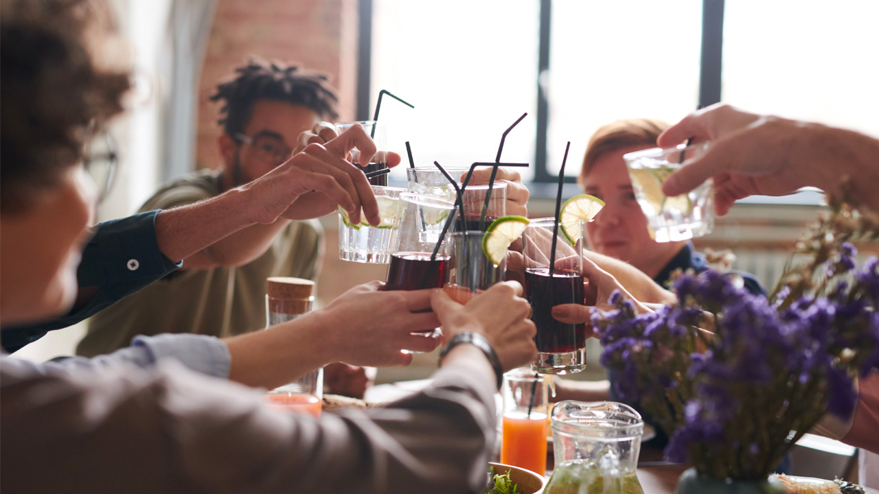 EOT Blog cover a group of people toast with a range of drinks in plastic cups